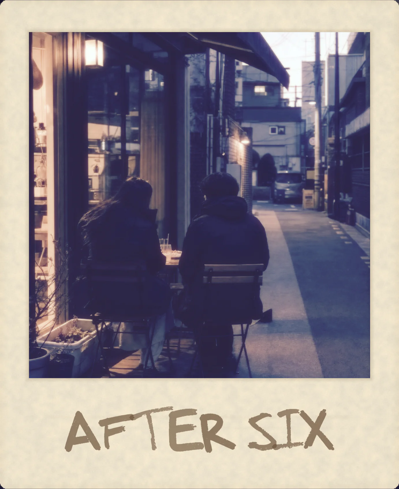 Two people at a dusk café in an aged paper frame