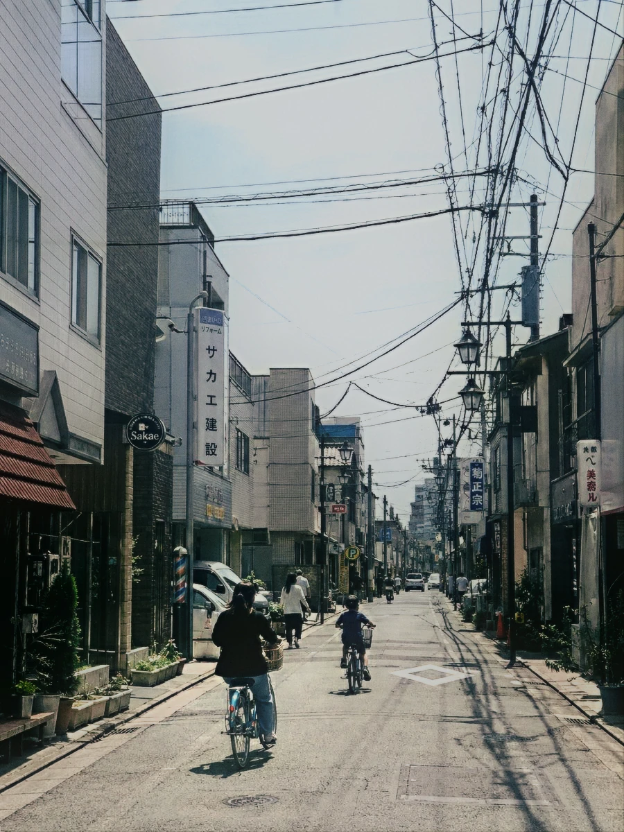 Cyclists on a residential street, before and after disposable-camera processing